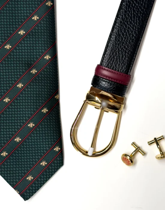 Men's accessories gift set with green tie, black belt with gold buckle and gold cufflink