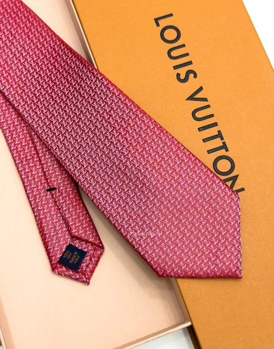 Raspberry red silk tie with repeating pink and white geometric pattern